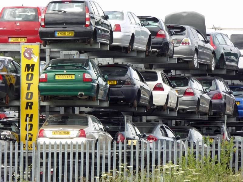 Vehicles lined up in a scrapyard